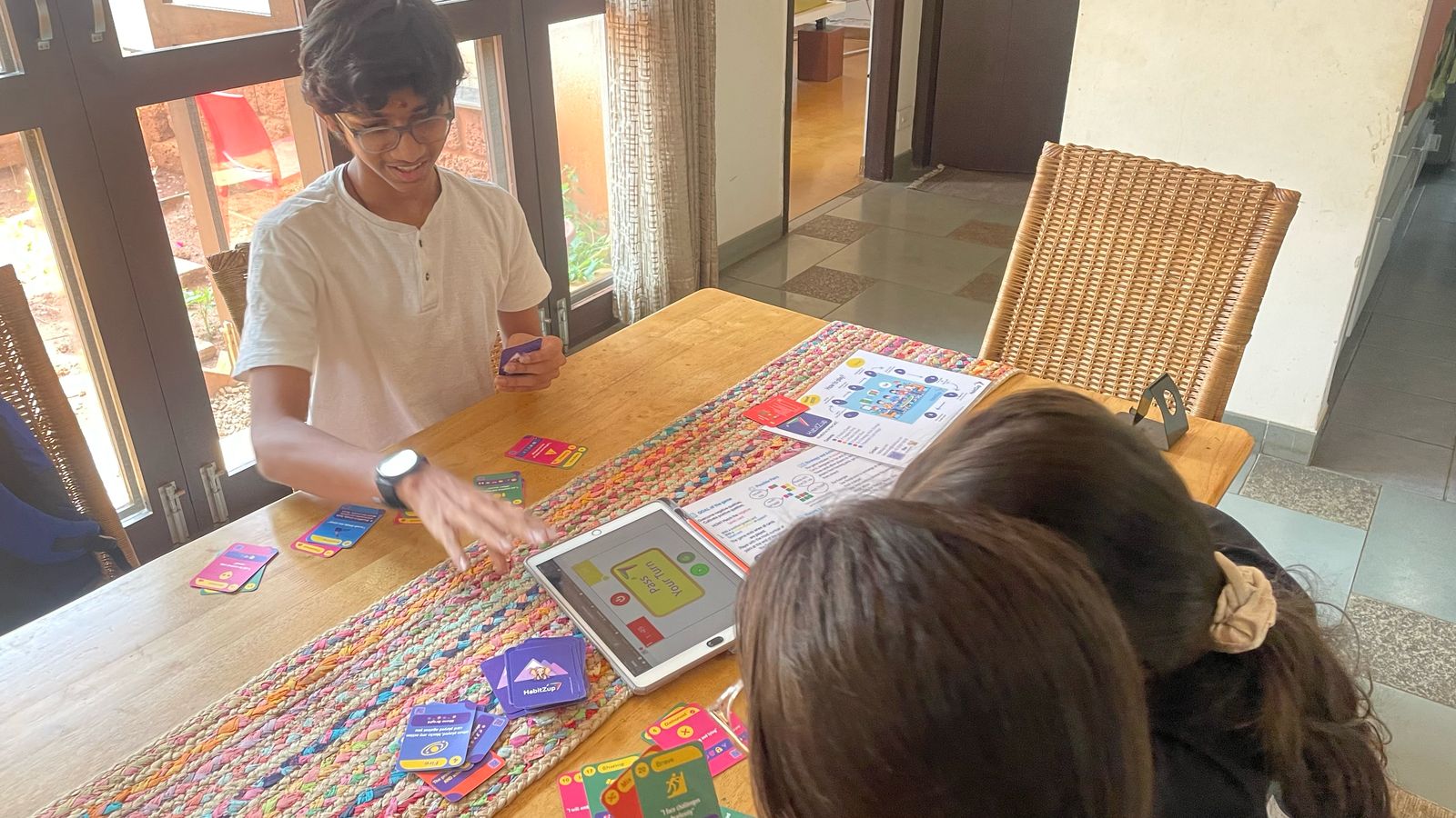 A family playing a card game together, laughing and connecting.